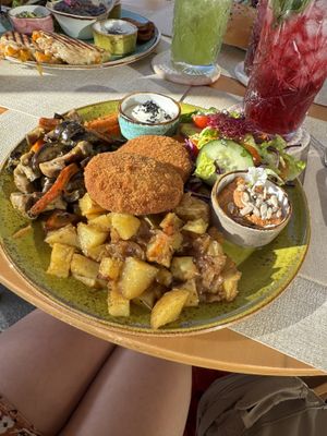 Chickpea fritters/ potatoes/vegetables . Drinks were berry iced tea and mint lemonade   at Alubia plant power in Mallorca