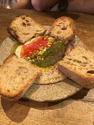 Hummus to share. The cilantro salsa on top is to die for  at Honest Greens - Fuencarral in Madrid
