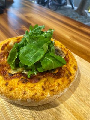 Pizza with rugula, crimini, caramelized onions, tomato souce and basil oil.
 at Coraje Vegan in Medellin