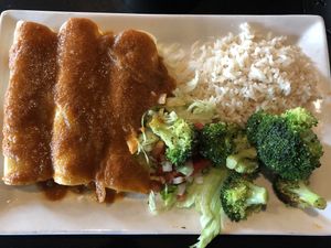 Guacamole Enchiladas with a red sauce and coconut rice.  at Botanas Restaurant and Bar in Branson