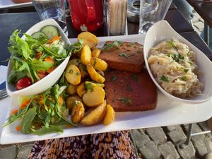Vegan Leberkäse with a side salad and cabbage  at Brauhaus Tünnes und Schäl in Cologne