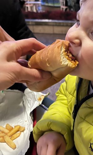 My toddler Enjoying chilli dog   at Disneyland - Casey's Corner in Chessy