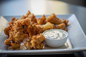 Vegan and gluten free these crispy cauliflower wings are a Maurya's creation. A creative traditional take with raita influenced dip (dip is not vegan) at Maurya's.Rest.Bar.Banquet in Kamloops