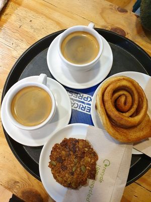 Americano coffees, cinnamon bun and breakfast cookie at Doppio Coffee Warehouse Kentish Town in North West London