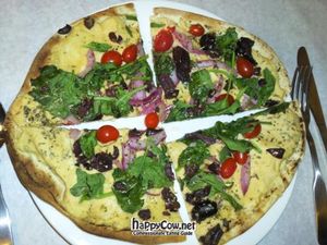 Mediterranean Pizza with hummus, tomatoes, spinach, kalamata olives & red onion. at Meditrina Market Cafe in Valparaiso