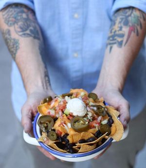Nachos with vegan cheese, black beans, jalapeños, soy cream and "Pico de Gallo". For the lovers of spicy food we serve them with lentils chili. Finger licking dish! at Gallo Santo in Barcelona