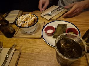 Patatas cabronas (patatas bravas), tamal at Gallo Santo in Barcelona