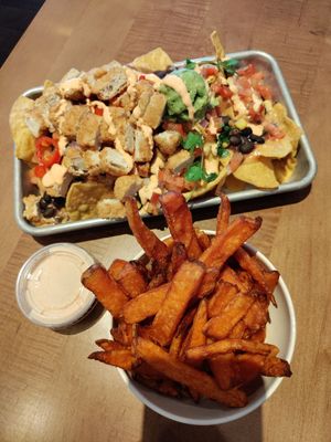 Southwest nachos (sub chick'n) + sweet potato fries at Veggie Grill by Next Level in Long Beach