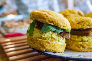 Pumpkin Cheddar Biscuit Sandwich with tofu scramble, vegan andouille sausage, organic greens. at Breads on Oak  in New Orleans
