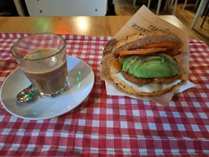 Oat milk coffee and falafel & avo bagel at Coffee & Bagel House in Berlin
