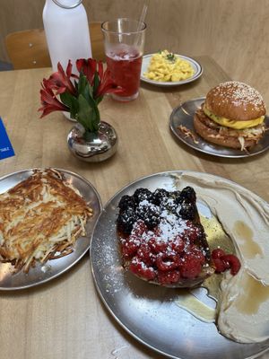 Our favorite restaurant 😍 100% vegan French toast, hash brown, scrambled Just egg, hibiscus tea, and two handed breakfast sandwich!  at Project Coffee - Rosemary in Sarasota