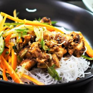 Almond Tofu over noodles topped with carrot, pepper cucumber slaw at Spoon and Sprout in Houston