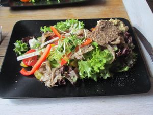 Salad with raw crackers and hummus at MO in Wroclaw