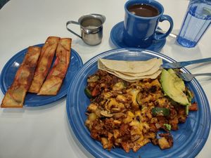 Soy bacon, vegetarian hash, and coffee with oat milk at Smile of the Beyond in Jamaica