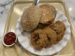 Homemade veggie burger with onion rings   at May Veggie Home Express - ประสานมิตรพลาซ่า in Bangkok