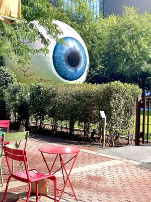 It’s located right next to the giant eyeball in downtown, and there are a few tables/chairs set up outside   at Starship Bagel in Dallas
