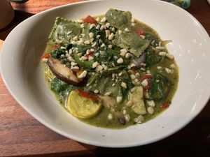 Vegan spinach mushroom ravioli in a pesto sauce with macadamia nuts on topp  at Keoki's Paradise in Koloa