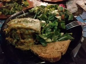 Half eaten lasagna (would be vegan without the cheese, which you could ask for) at Sativa Studio Cafe in Banos