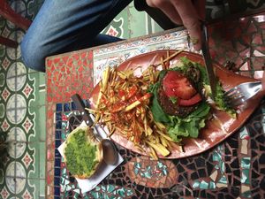 Burger and fries  at Sativa Studio Cafe in Banos