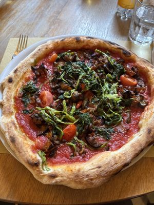 Tomato sauce, fresh tomato, and some green leaves Italian people commonly eat  at PizzaRé in Rome