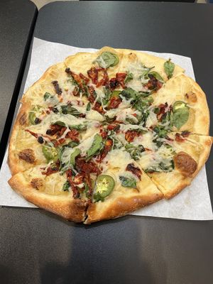 Build your own pizza with vegan artichoke sauce, vegan cheese, sun dried tomatoes, jalapeños, and spinach.   at 2 Guys Pies Brick Oven Pizza in Yucca Valley