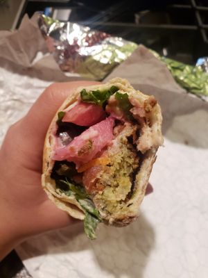 falafel, tomato, hummus, pickled veggies, mixed greens, and all rolled in fresh pita bread at Aladdin's Eatery in Mishawaka