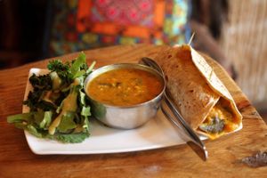 The Gypsy roti roll (mango, eggplant, tomato & rice) comes with dahl and salad.  Tell them if you want it vegan, otherwise the eggplant is cooked with a bit of yogurt. at East is East - Broadway in Vancouver
