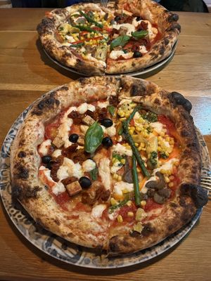 New on the menu! 😊 1/2 vegan recycle pizza (left) and 1/2 garden pizza with substituted vegan cheese (right). Both delicious!  at Pizzeria Orli in Golnik
