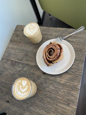 Cinnamon bun and lattes with oat milk   at Feast & Fallow in Vancouver