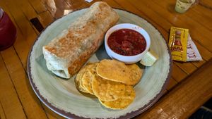 Very voluptuous vegan burrito (bland despite the description) Black beans, rice, spinach, cabbage, corn salsa, pickled onions, poblano sauce & avocado. at Sexi Mexi Burrito Bar in Winchester