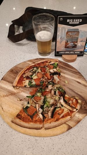 Vegan pizza and beer. Cheese underneath as is best on a vegan pizza! at Outback Bar And Grill in Coober Pedy