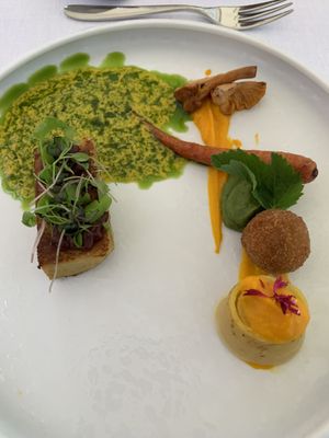 Carrot purée, veggie croquette, saffron based crepe (not quite sure how to describe it) and another light and super tasty with onion sauce on top yummy  at Ertlio Namas in Vilnius