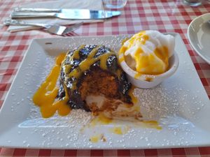 Fluffy vegan orange cake with warm chocolate sauce , orange sorbet and mango drizzle at Nancy's Barn in Ballyliffin