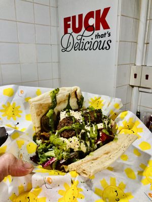 “Gap Year” Hot Falafels and Hummus with harissa roast veg, tabouleh, leaves and a coriander emulsion, served in a warm Turkish flat bread.  at THE COVEN of WICHES in East London