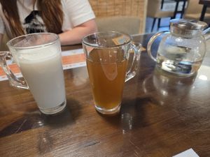 Coconut drink (warm) plus a drink made of different stuff like dates and its consistency is like agave syrup! You can choose warm or cold at Baiyi Vegetables Lanzhou Sulamian - 百易素食·素拉面（元大都店) in Beijing