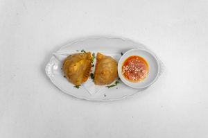 Vegetable Samosa:
Fried pastry filled with a mixture of potatoes, peas, cashews, and spices. at Tandoor King Indian Restaurant in Karlovy Vary