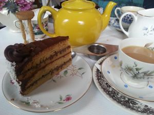 Vegan chocolate and coconut cake with tea in the secret tearoom at Norman's Coach and Horses in London