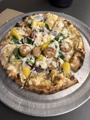 Cashew Alfredo base, onions, spinach, pineapple and beyond bratwurst pizza   at Humble Wood Fire Pizza in Gainesville