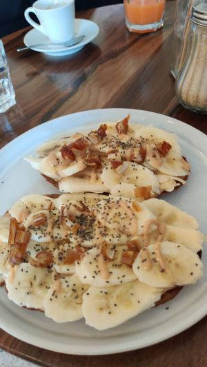 Peanut butter and banana toast topped with chia seeds and chopped up dates at Alma Kitchen & Coffee in Tangier