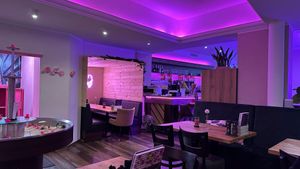 Tables and neon lights inside at Smashup! in Aachen