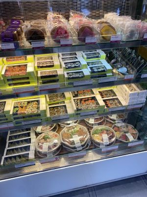 Vegan sushi boxes have a green shelf label  at Wasabi - Shaftesbury Ave in London