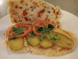 Homemade flatbread and humous with pickled gherkin, tomato and coriander. at Blaeberry House in Inverness