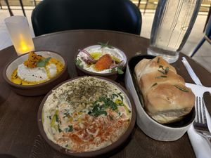 Hummus and other appetizers Herb Bread  at Anixi in New York City
