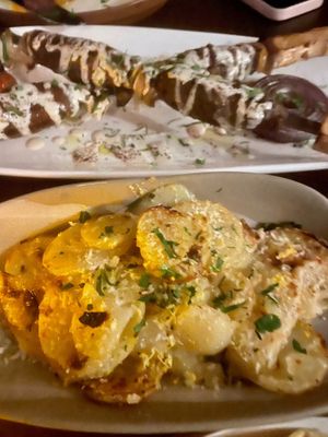KOFTA KABOB (top) - Cinnamon and cumin infused “beef,” tahini, parsley, sumac
CONFIT POTATOES (bottom)- Lemon zest, garlic chips, parsley at Anixi in New York City