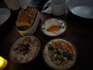 3 Mezze with Taramasalata, Hummus Masabacha, and Fire Roasted Eggplant. Plus Layered herb bread at Anixi in New York City