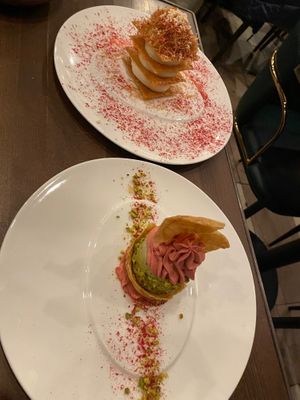 Our desserts (the raspberry pistachio one was outstanding, but the flaky white cream one the server recommended was sadly underwhelming) at Anixi in New York City