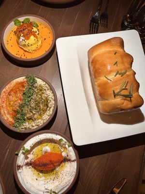 Three dips - Taramasalata, Hummus Masabacha, and Whipped Ricotta.   at Anixi in New York City