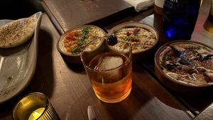 Three small plates with z’Atar pita, piping hot and all delicious   at Anixi in New York City