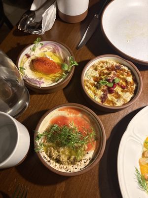 Trio of dipping mezzes: yogurt with caviar, olive tahini, and aubergine  at Anixi in New York City