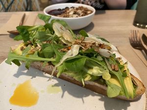 Avocado on toast with granola bowl in background   at British Patagonia in North London